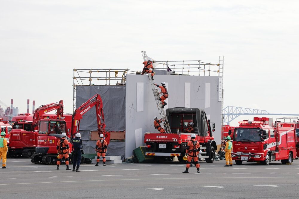 建物倒壊現場の救助訓練。高機動救助車（ウニモグ）の荷台からはしごを使い救助に向かう様子